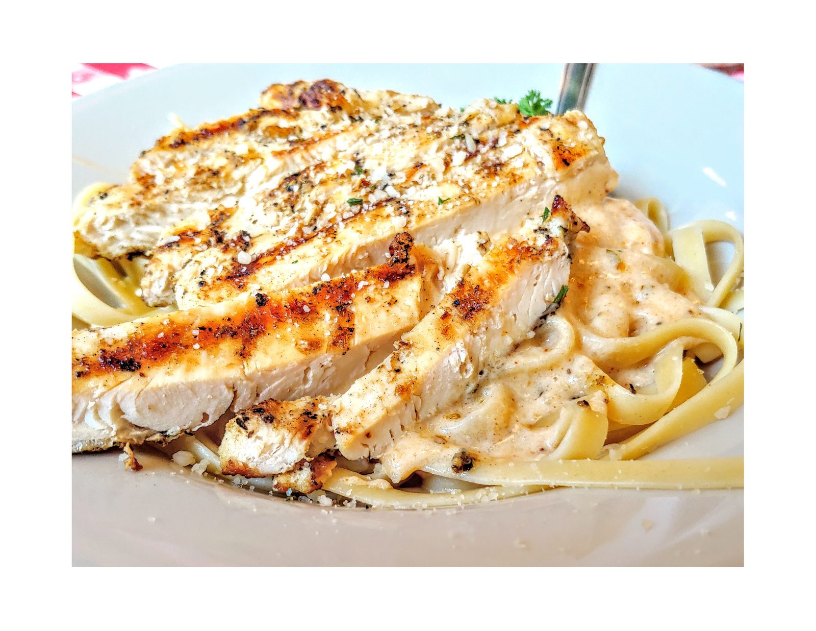 Loaded chicken fettuccine alfredo with grilled chicken, bacon, mushrooms and broccoli