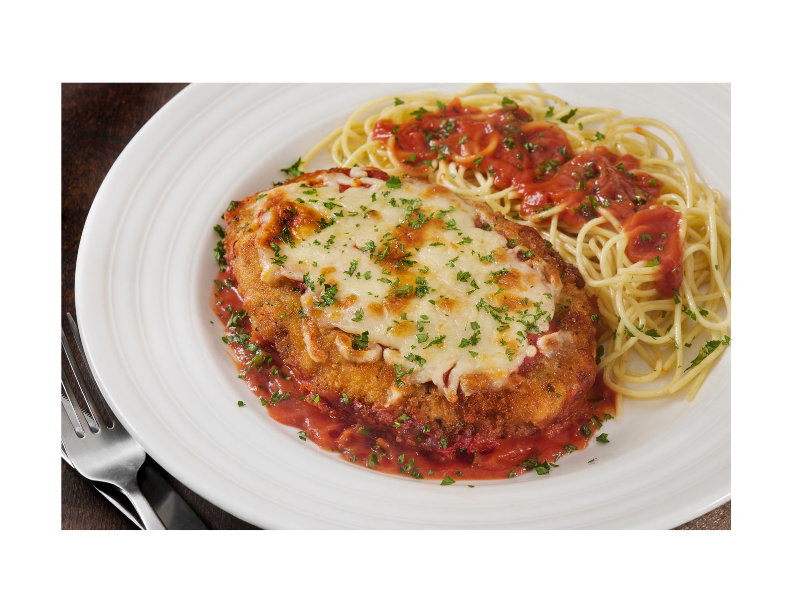 Baked Chicken Parmigiano on spaghetti with marinara and melted mozzarella