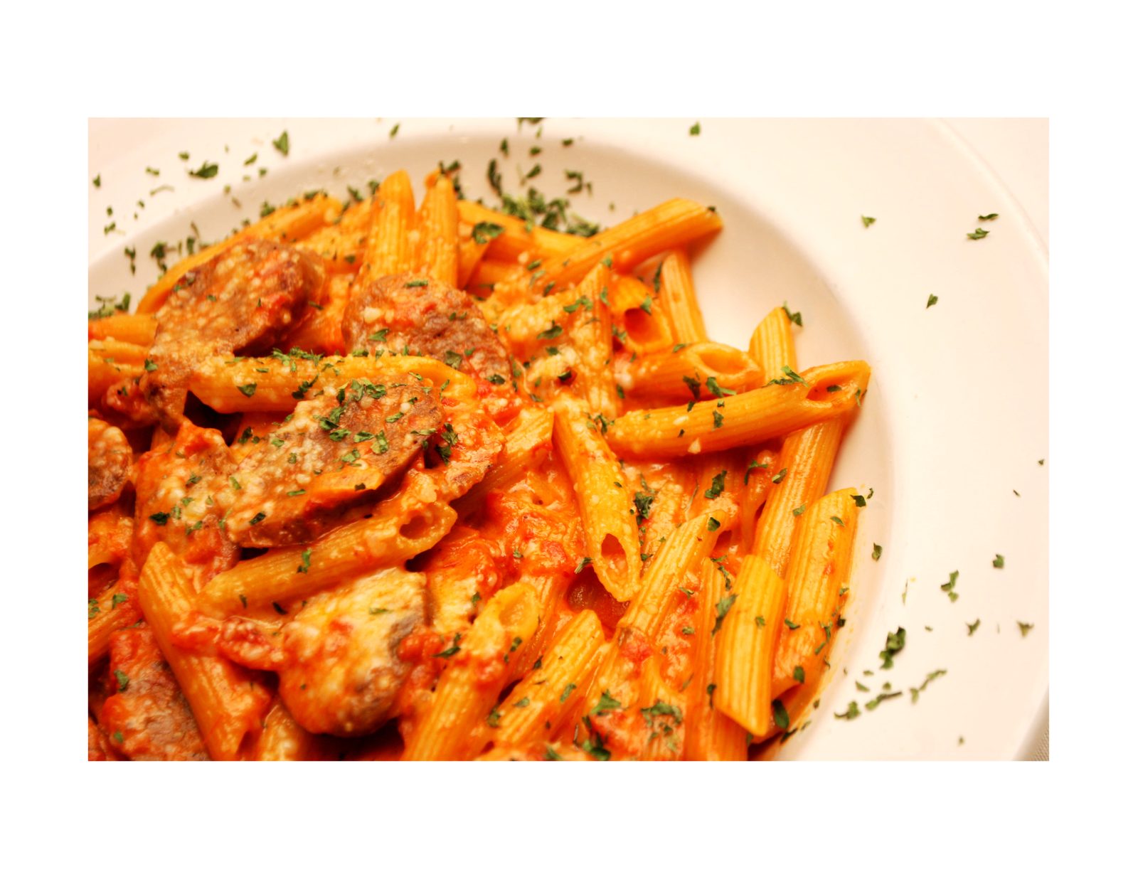 Penne alla vodka with chicken in pink vodka cream sauce and fresh basil